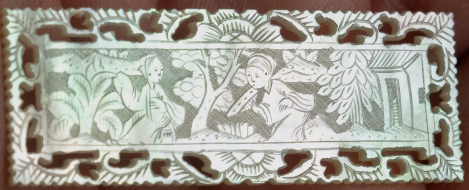 Intricate carved panel featuring floral and fauna designs in relief.