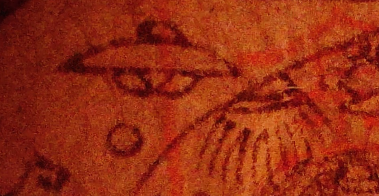 A stylised drawing of a UFO with concentric circles and a dotted design nearby.