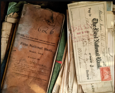 Old documents, including a ledger and letters, with stamps and handwritten notes.